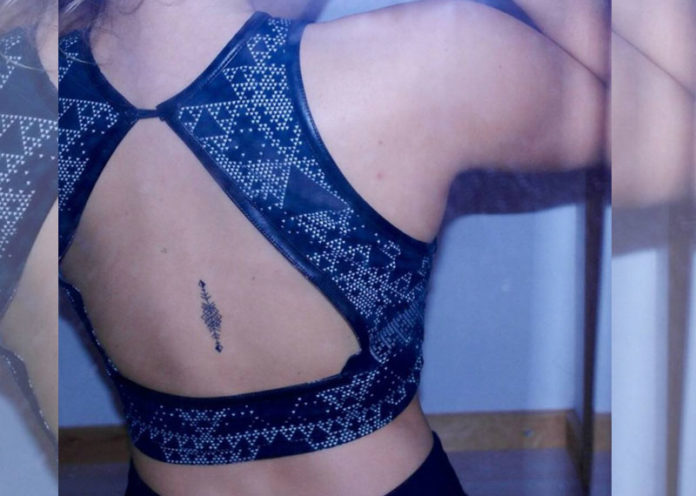 Double arrow back tattoo