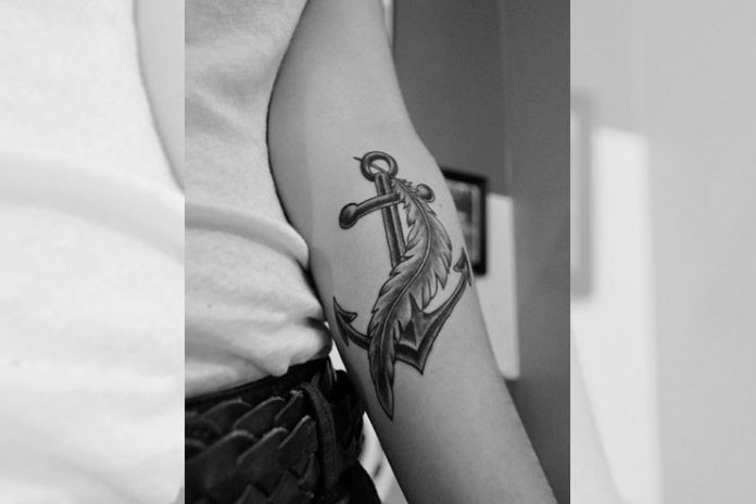 Anchor and feather tattoo