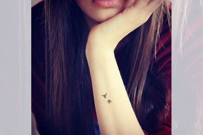 Tiny bird tattoos on arm